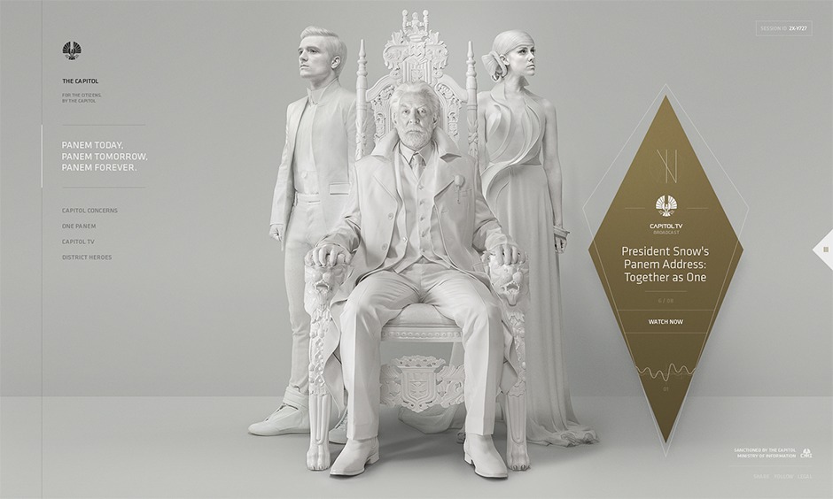 Page d'accueil de Thecapitol.pn - Président Snow entouré de Peeta Mellark et deJohanna Mason, tous immaculés de blanc tels que des statues